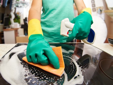 Cleaner preparing a high-rise Canary Wharf flat for move-out inspection